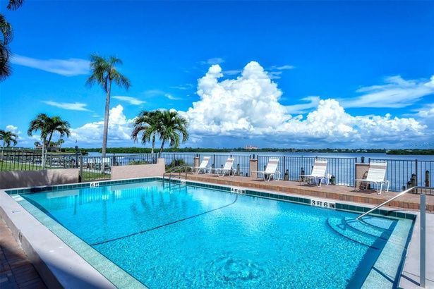 40-foot heated pool between Buildings 3 and 4 with lounge chairs and bay view