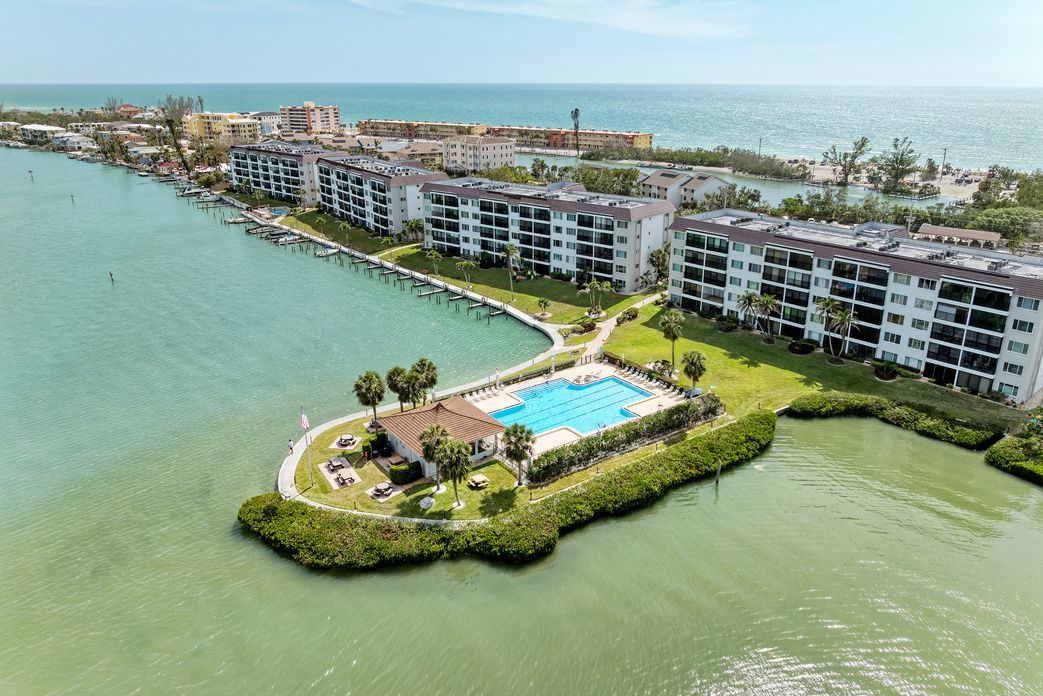 Aerial view of Sunrise Cove's waterfront pool and cabana on Sarasota Bay