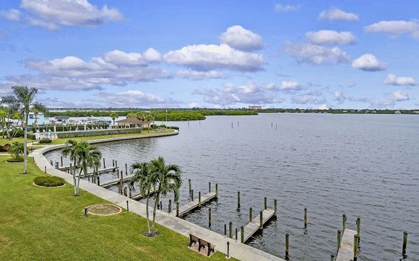 Dock slips and seawall walkway curving along Sarasota Bay